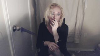 Goth Tranny smokes and pleasures herself.